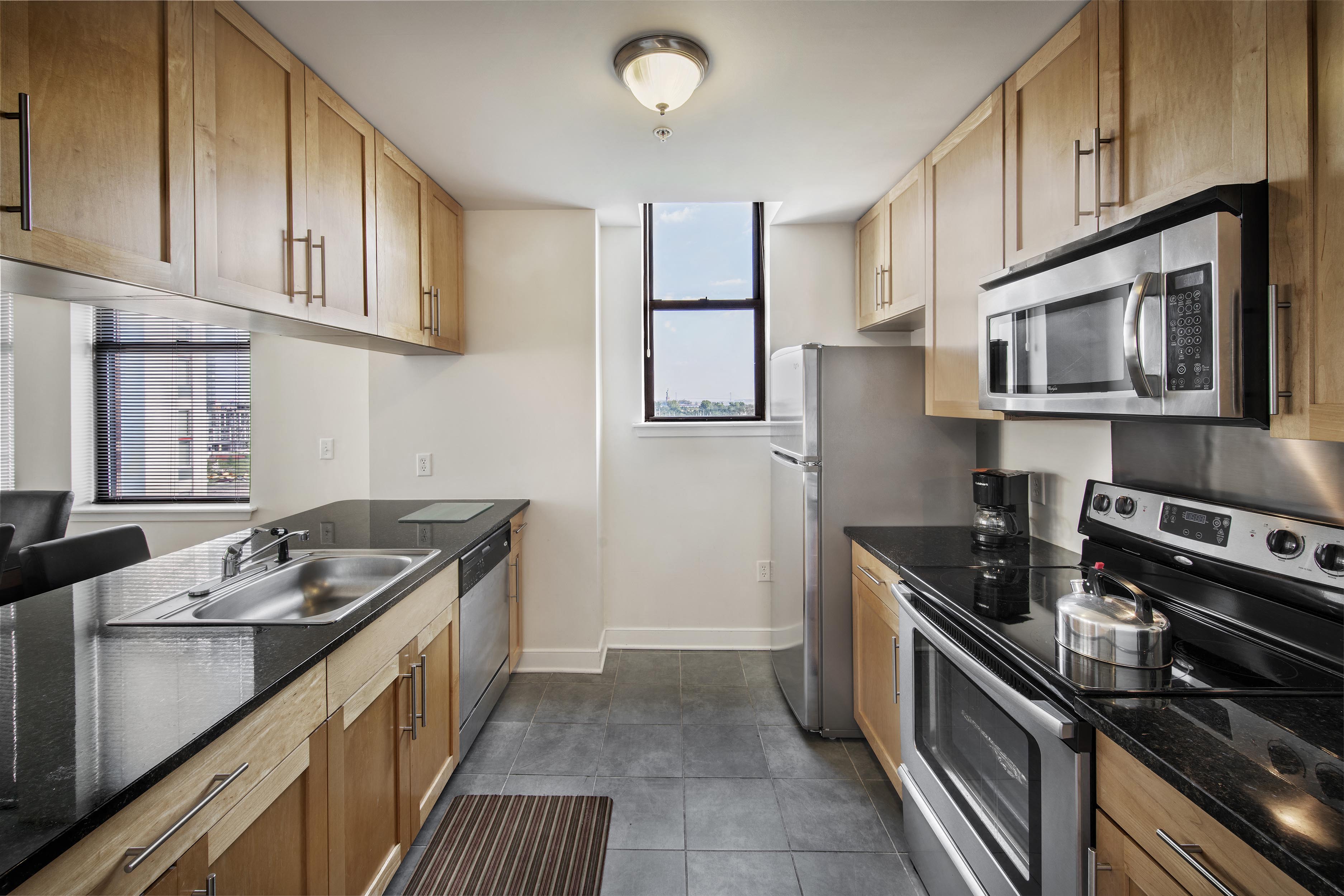 A kitchen with wooden cabinets and stainless steel appliances.