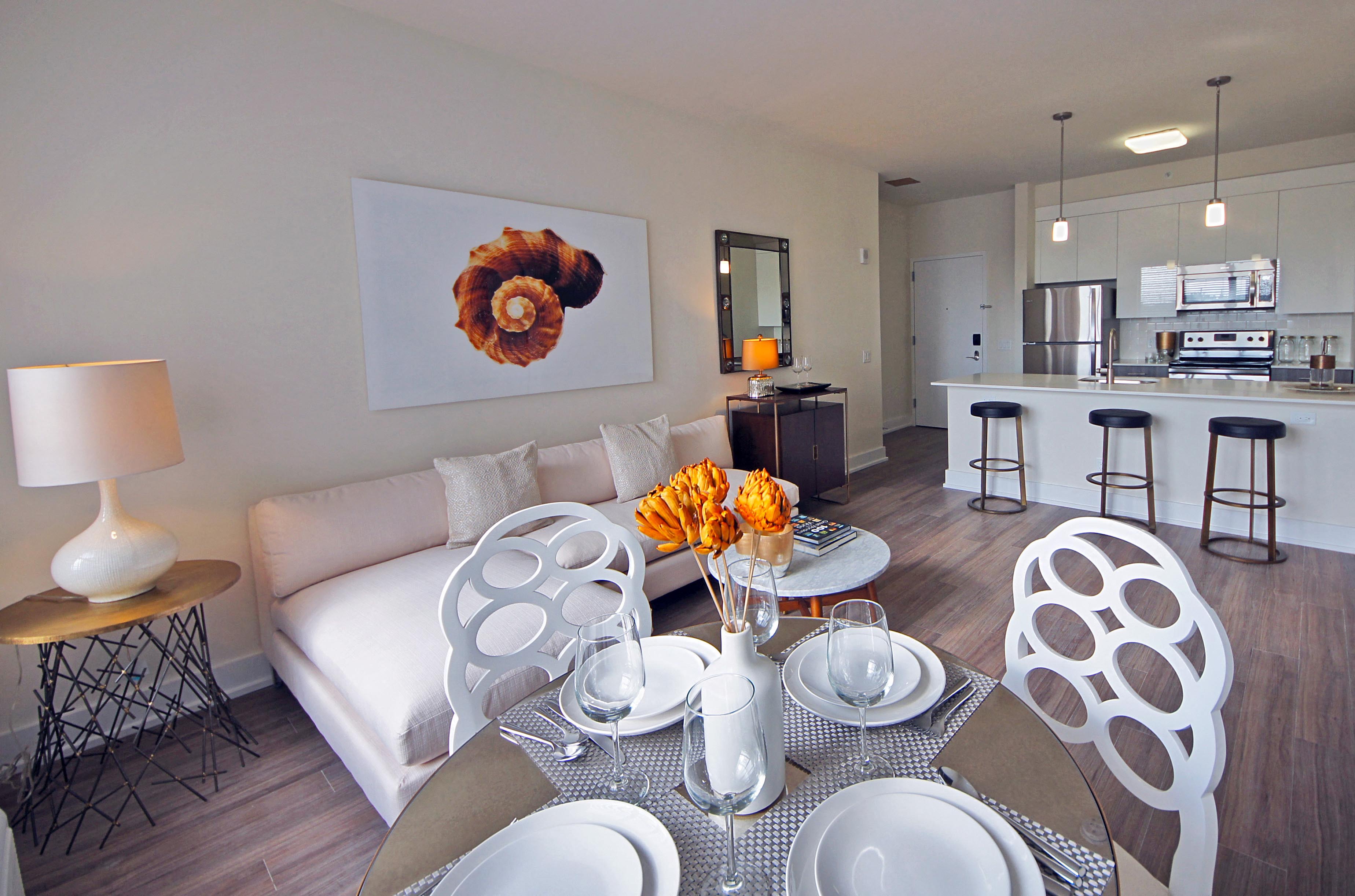 a living room and dining room with a table and chairs