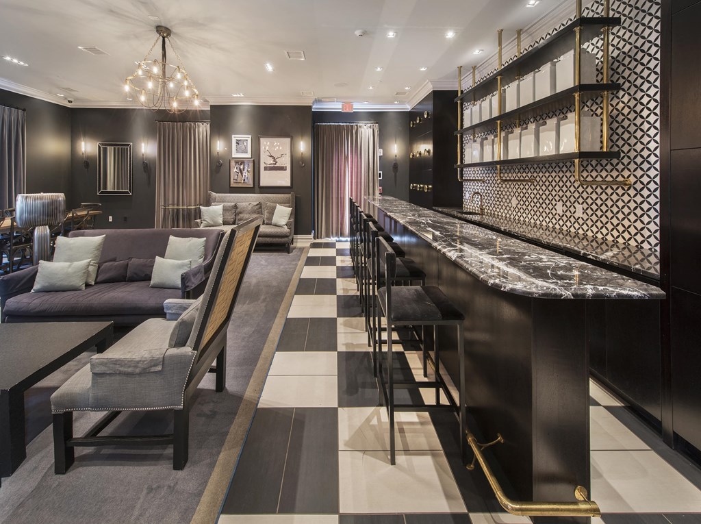 the lobby of a hotel with a bar and couches