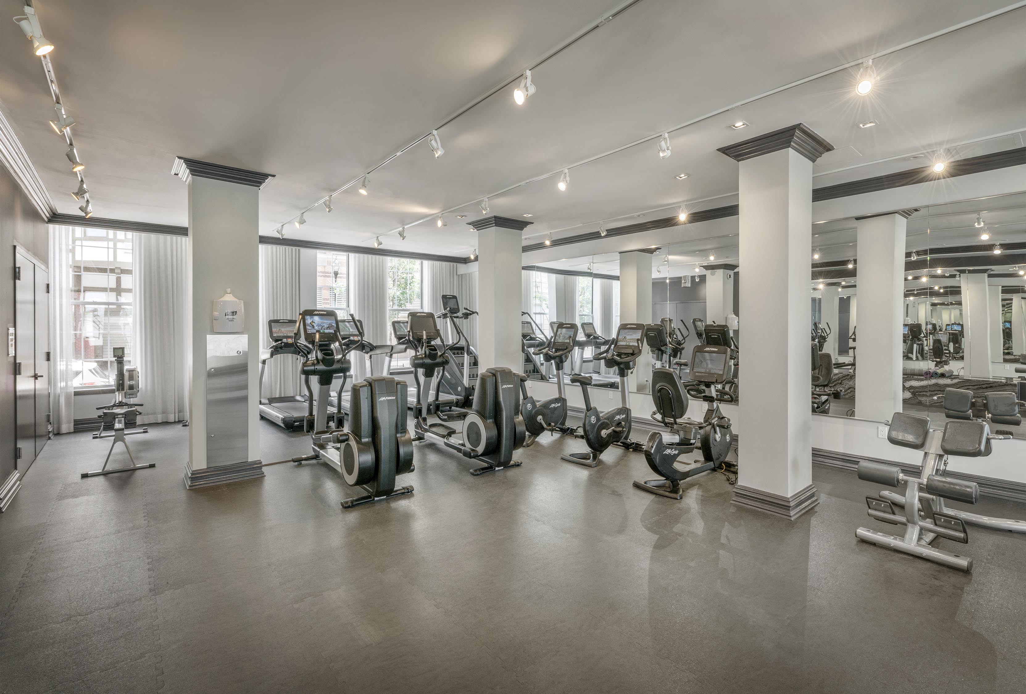a gym with treadmills and other exercise equipment