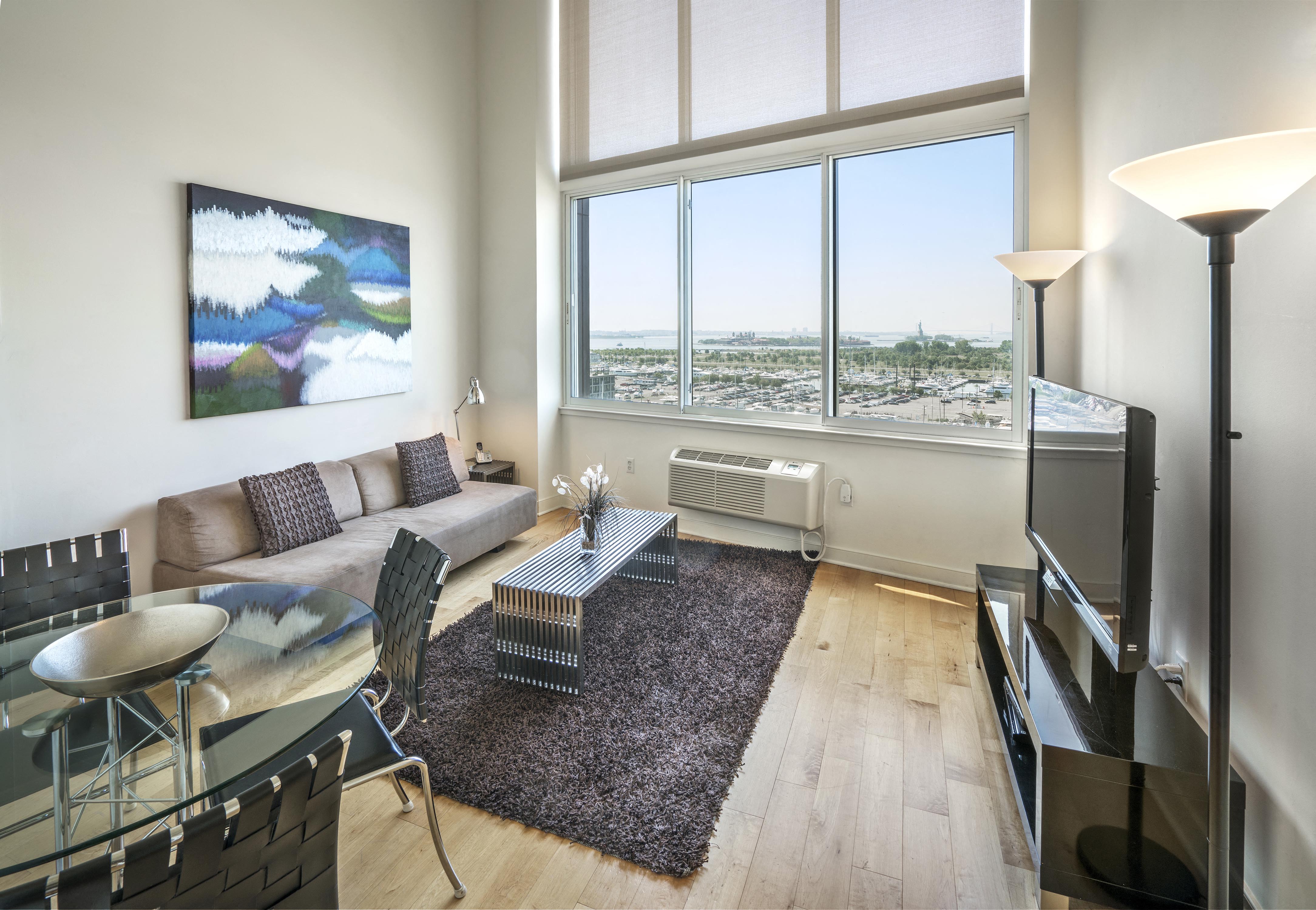a living room with a large window and a couch and a table