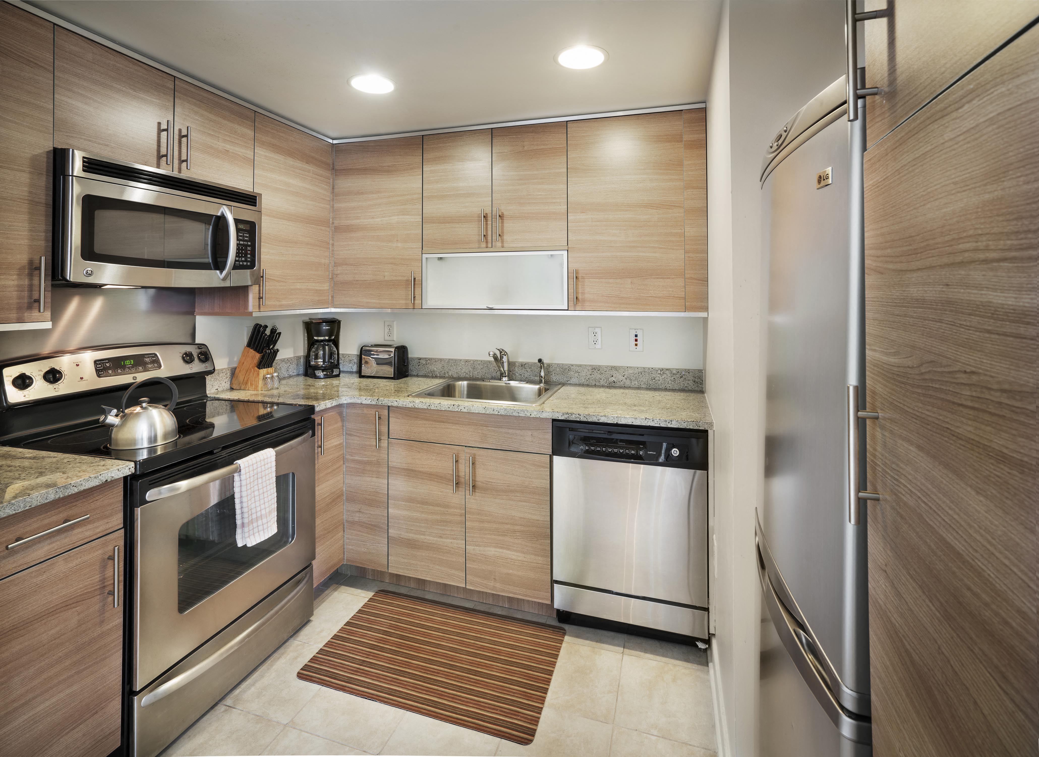 a kitchen with stainless steel appliances and wooden cabinets