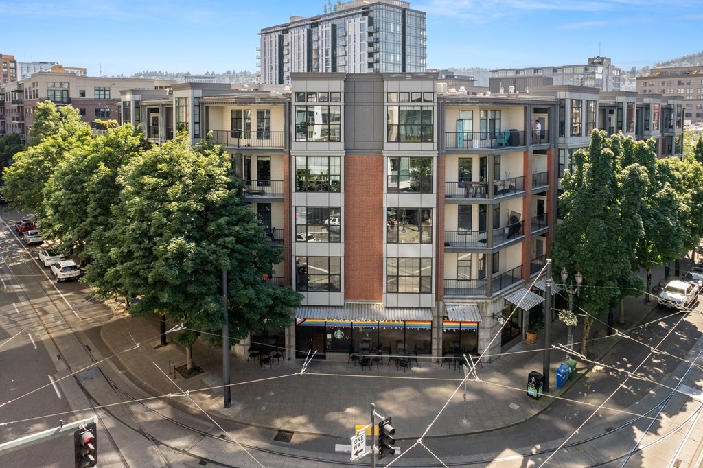 an aerial view of a building with trees in front of it