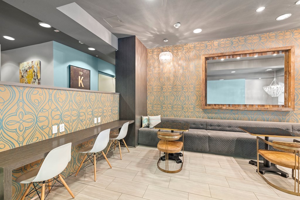 a dining area with tables and chairs and a couch