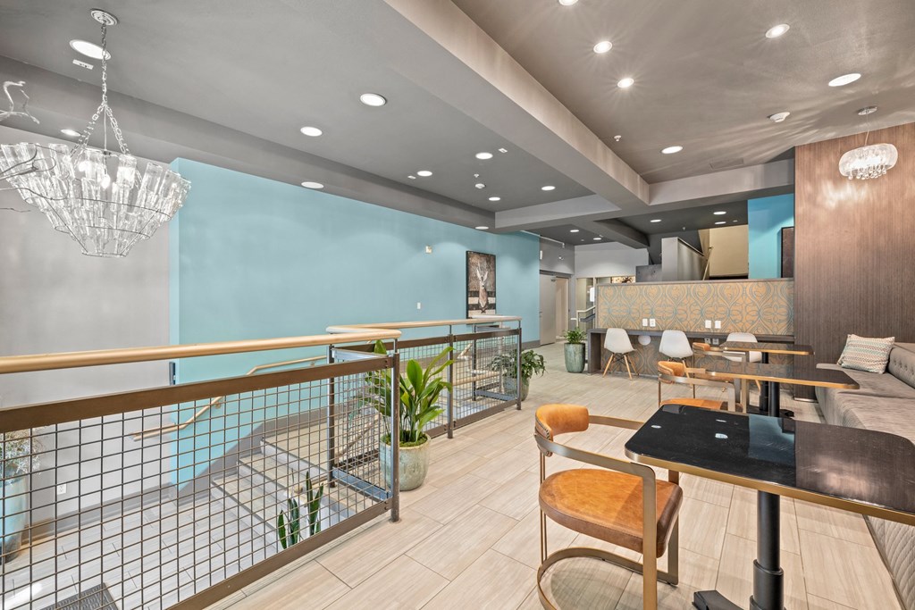 a dining area with tables and chairs and a chandelier