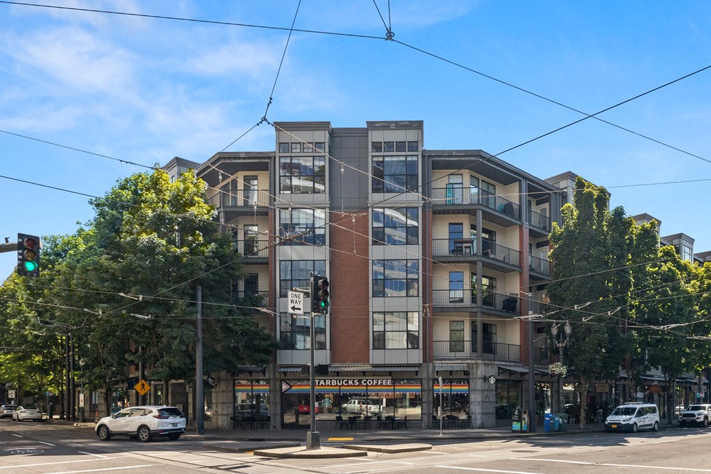 a large apartment building on the corner of a city street