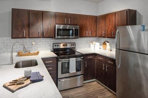 a kitchen with stainless steel appliances and wooden cabinets