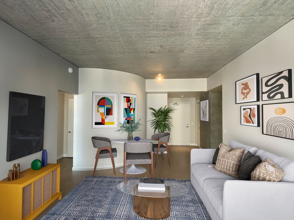 a living room with a white couch and a table with chairs