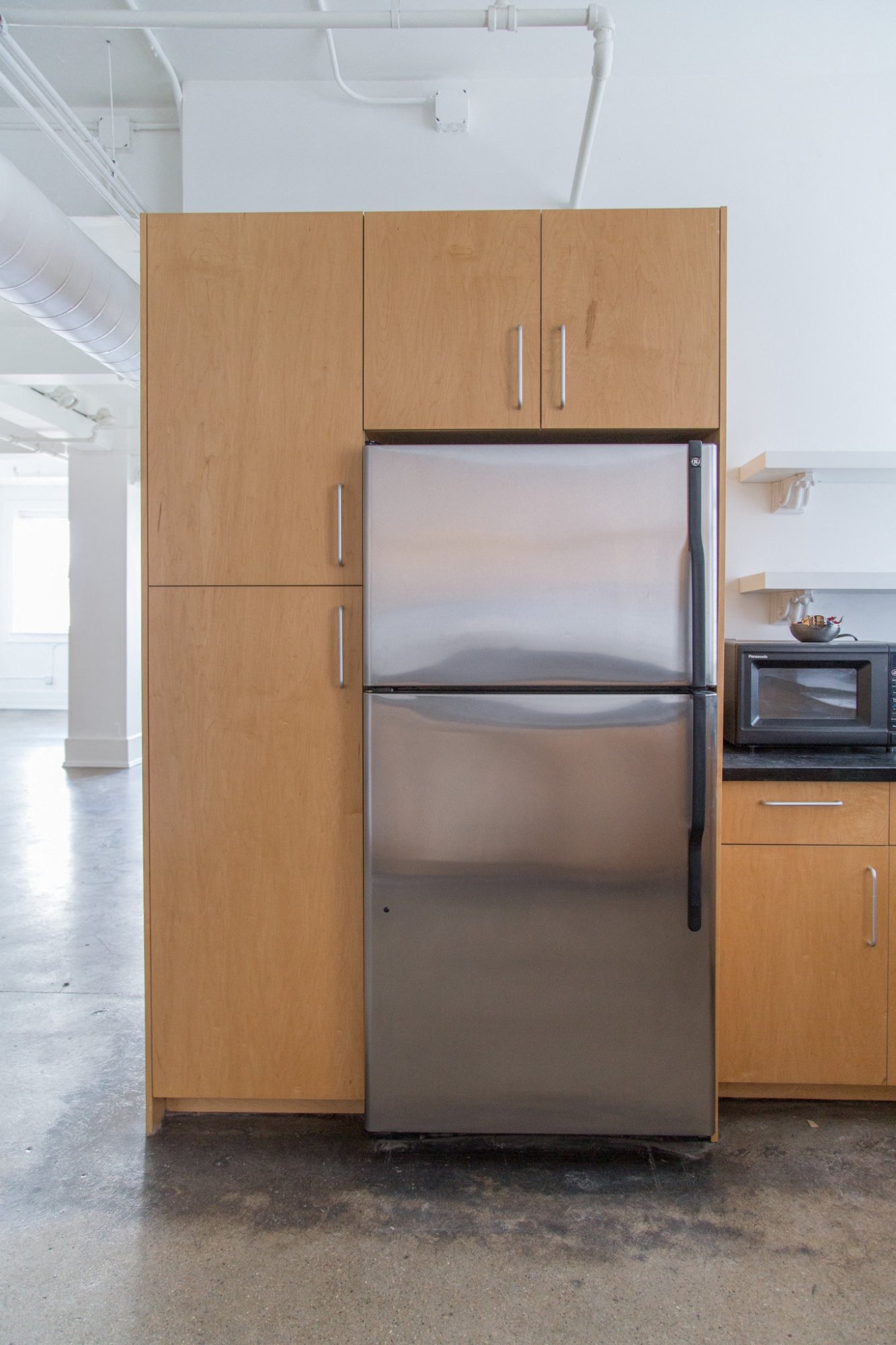 a stainless steel refrigerator and cabinets in a kitchen