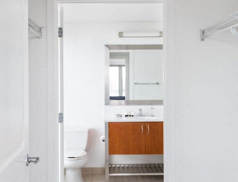 a bathroom with a toilet and a sink and a mirror