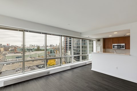 A large empty room with a view of the city.