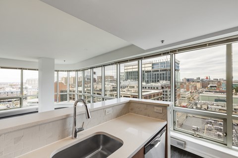 A modern kitchen with a view of the city.