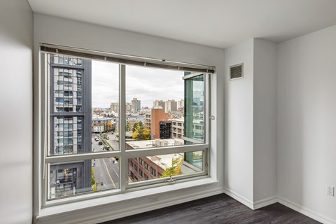 A room with a large window overlooking a city street.
