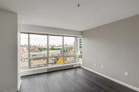 A large empty room with a view of the city.