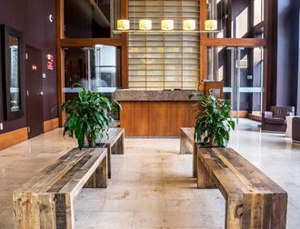 a lobby with benches and potted plants