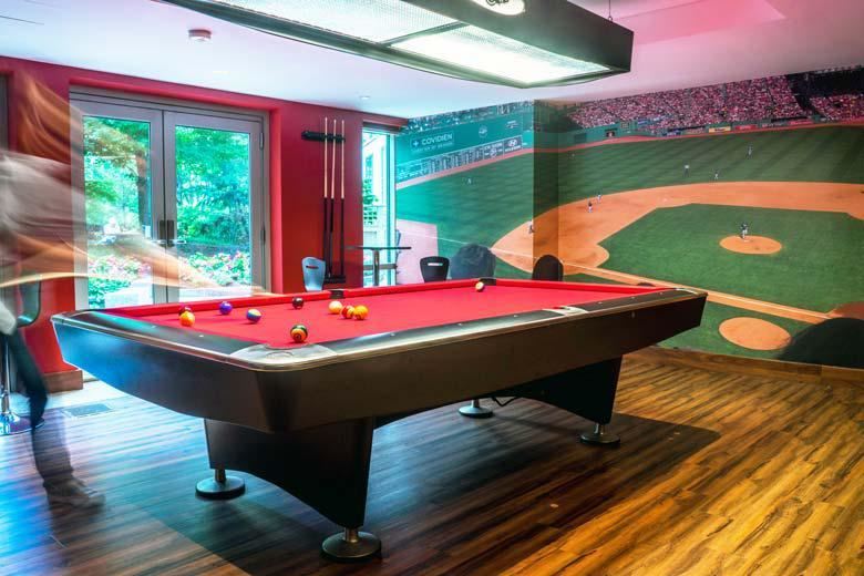 a pool table in a room with a baseball field