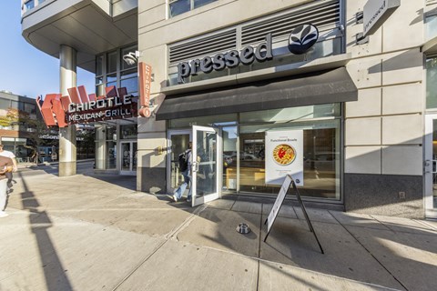 A Chipotle Mexican Grill restaurant is located in a building with a Pressed sign above it.