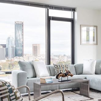 a living room with a city view and a couch and a coffee table