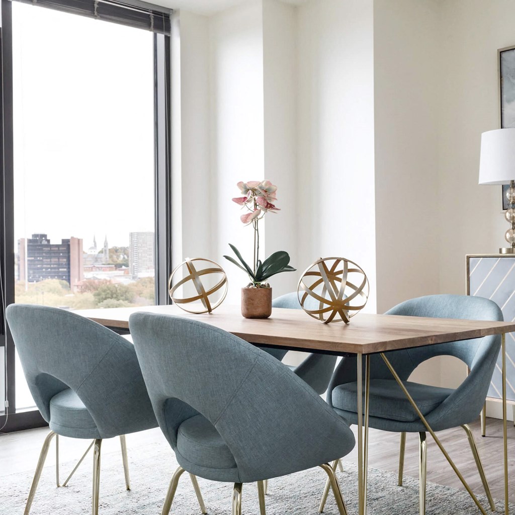 a dining room with a wooden table and blue chairs