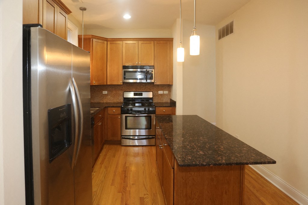 a kitchen with stainless steel appliances and granite counter tops