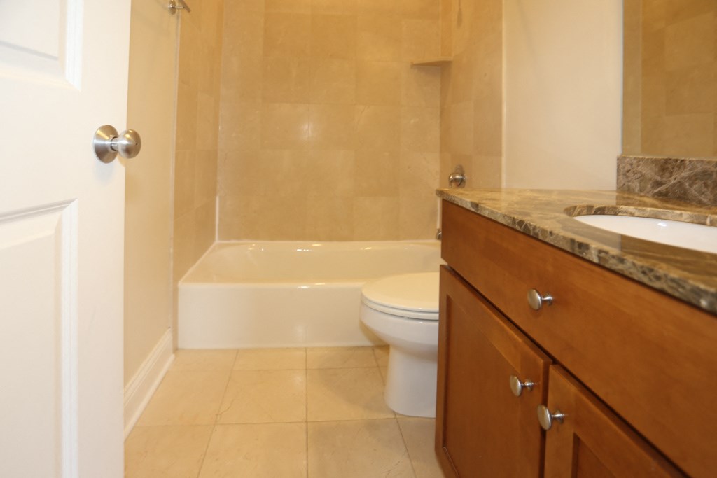 a bathroom with a toilet and a sink and a tub