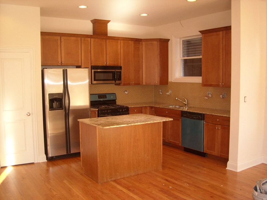 a kitchen with stainless steel appliances and wooden cabinets