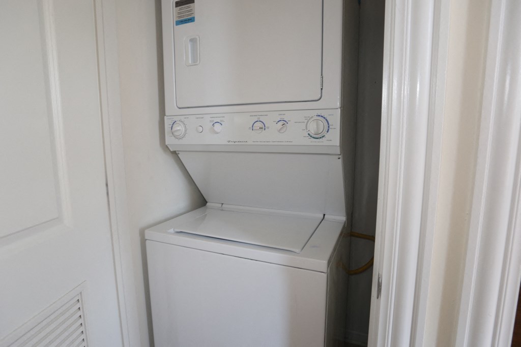 a washer and dryer in a white utility room
