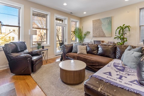 a living room with leather couches and a coffee table