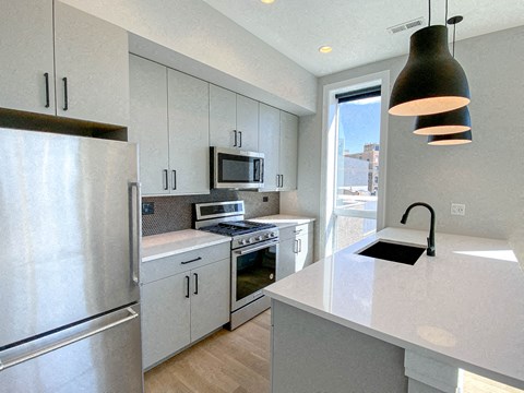 a kitchen with stainless steel appliances and white cabinets