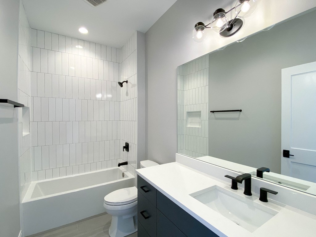 a bathroom with a sink and a toilet and a tub