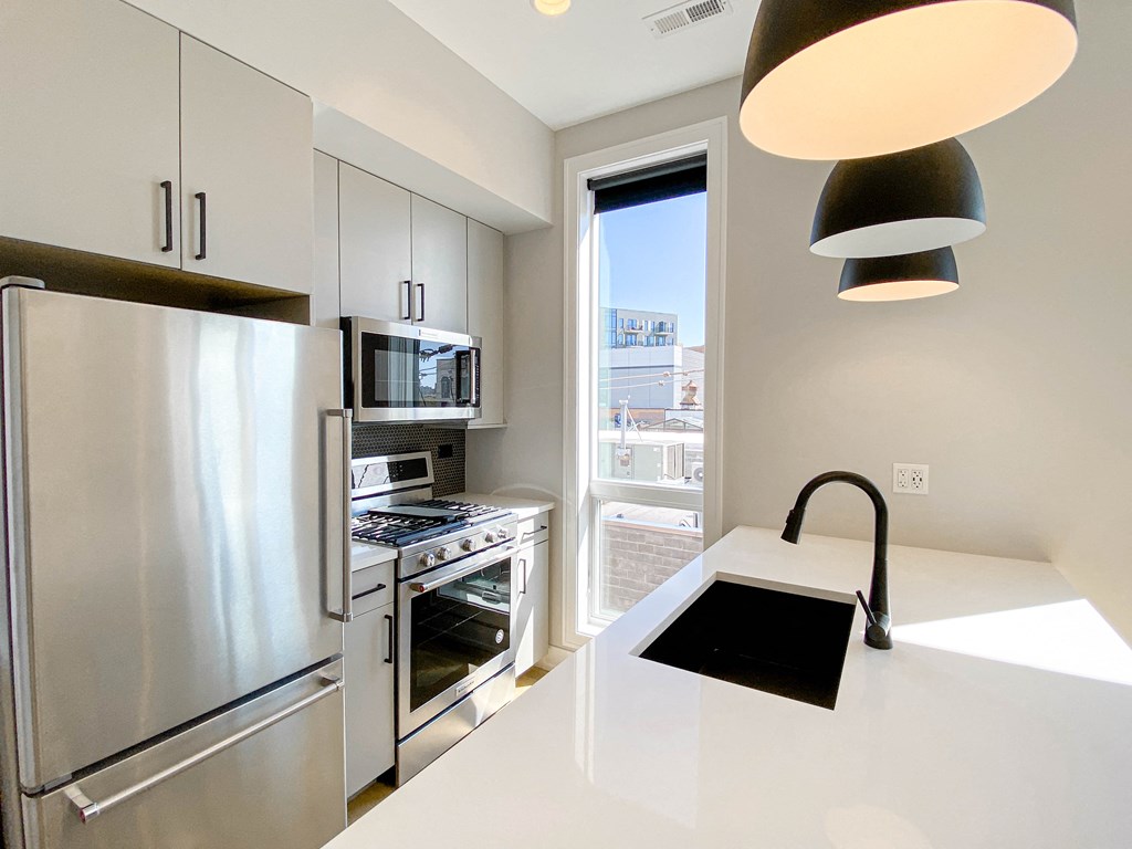 a kitchen with stainless steel appliances and a window