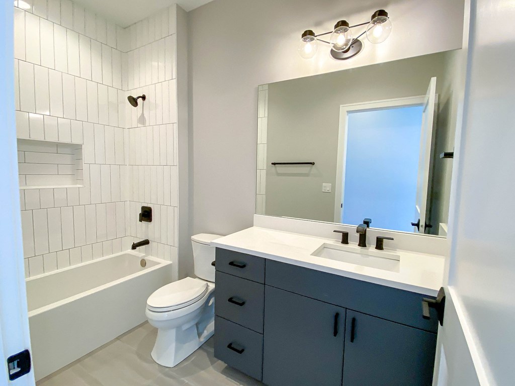 a bathroom with a sink toilet and a tub