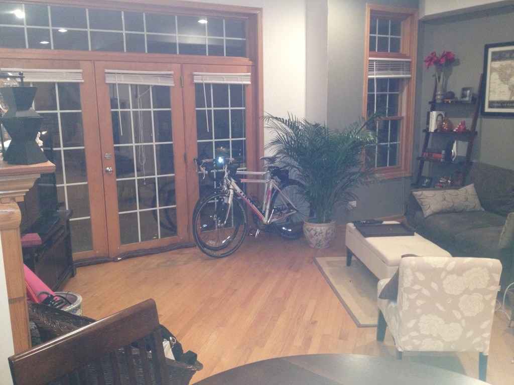 a living room with a bike in the corner