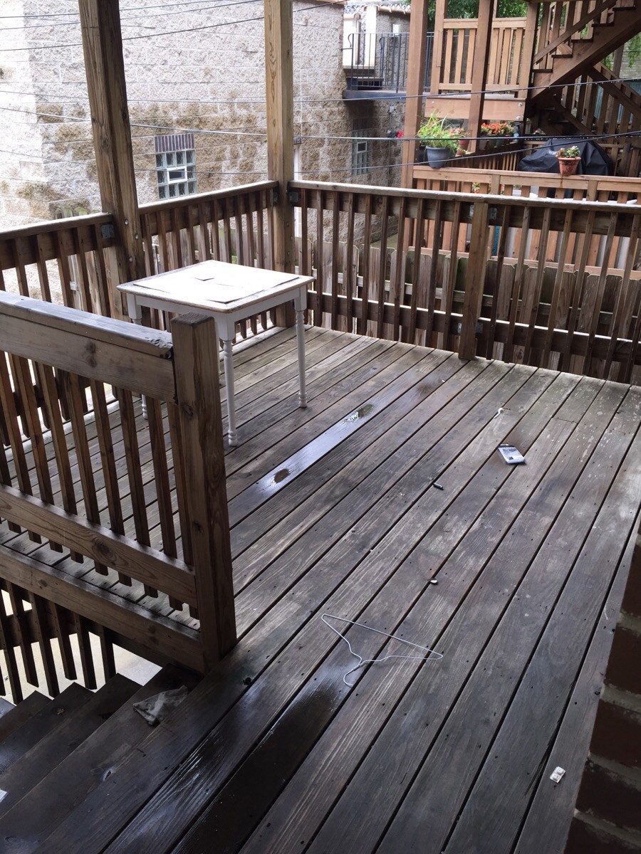 a wooden deck with a table on it
