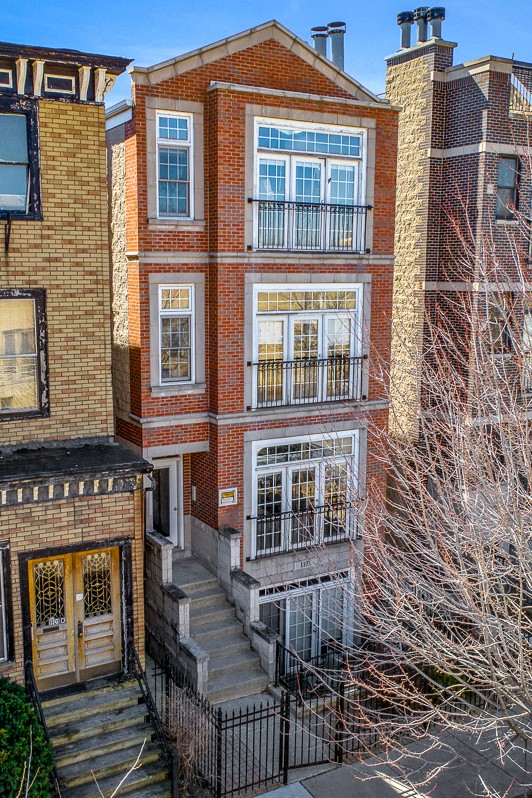 the front of a brick building with a staircase