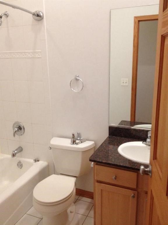 a white bathroom with a toilet and a sink