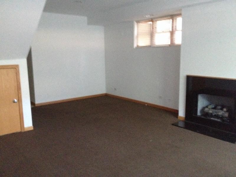 an empty living room with a fireplace