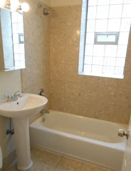 a bathroom with a sink and a bath tub