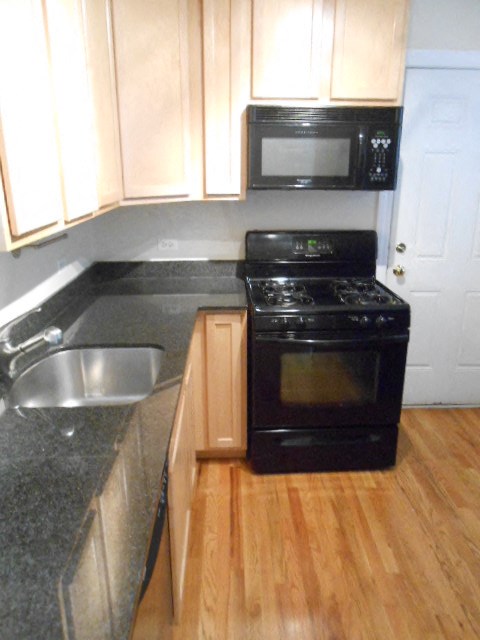 a kitchen with a stove and a sink