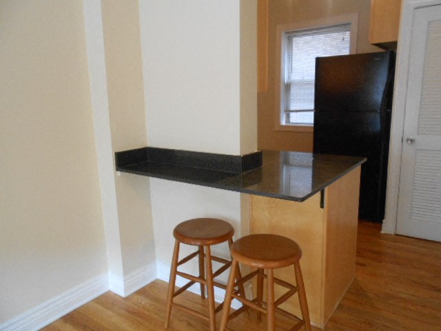a kitchen with two stools and a counter top