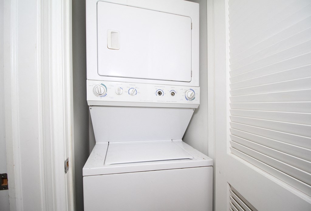 an empty laundry room with a washer and dryer