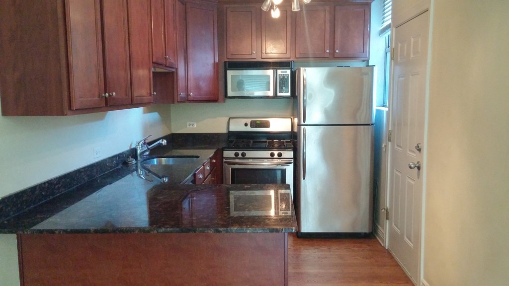 a kitchen with granite counter tops and stainless steel appliances