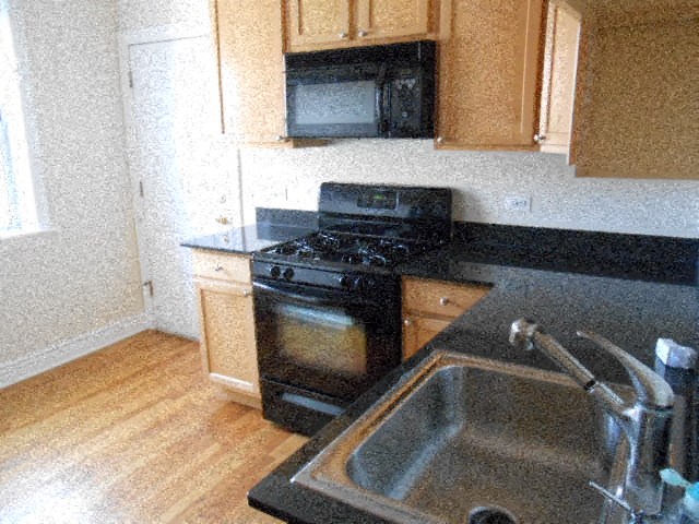 a kitchen with a stove and a sink