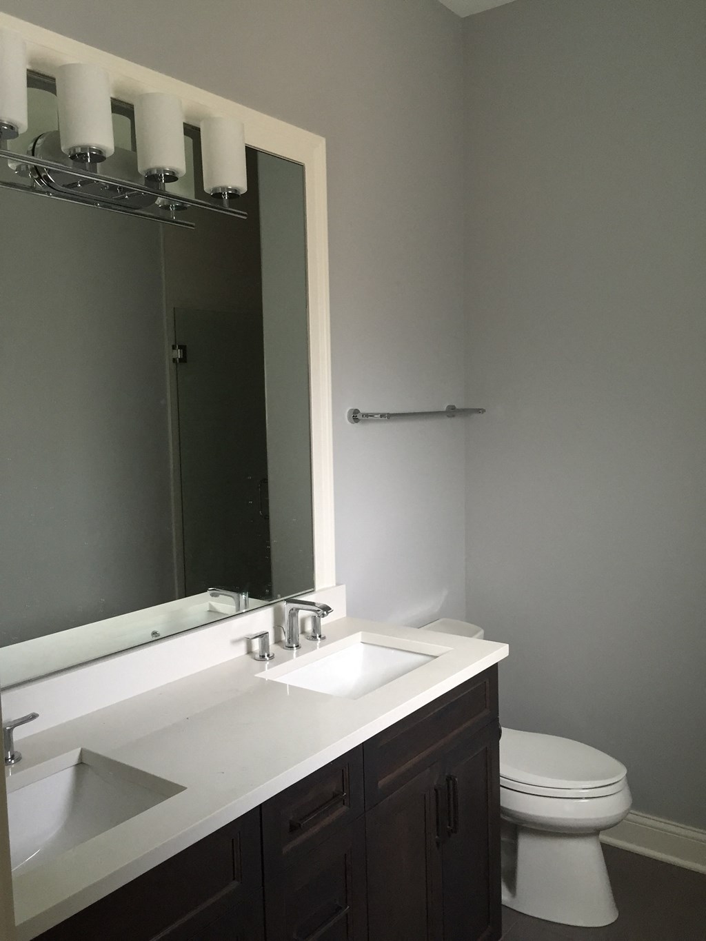 a bathroom with a toilet and a sink and a mirror