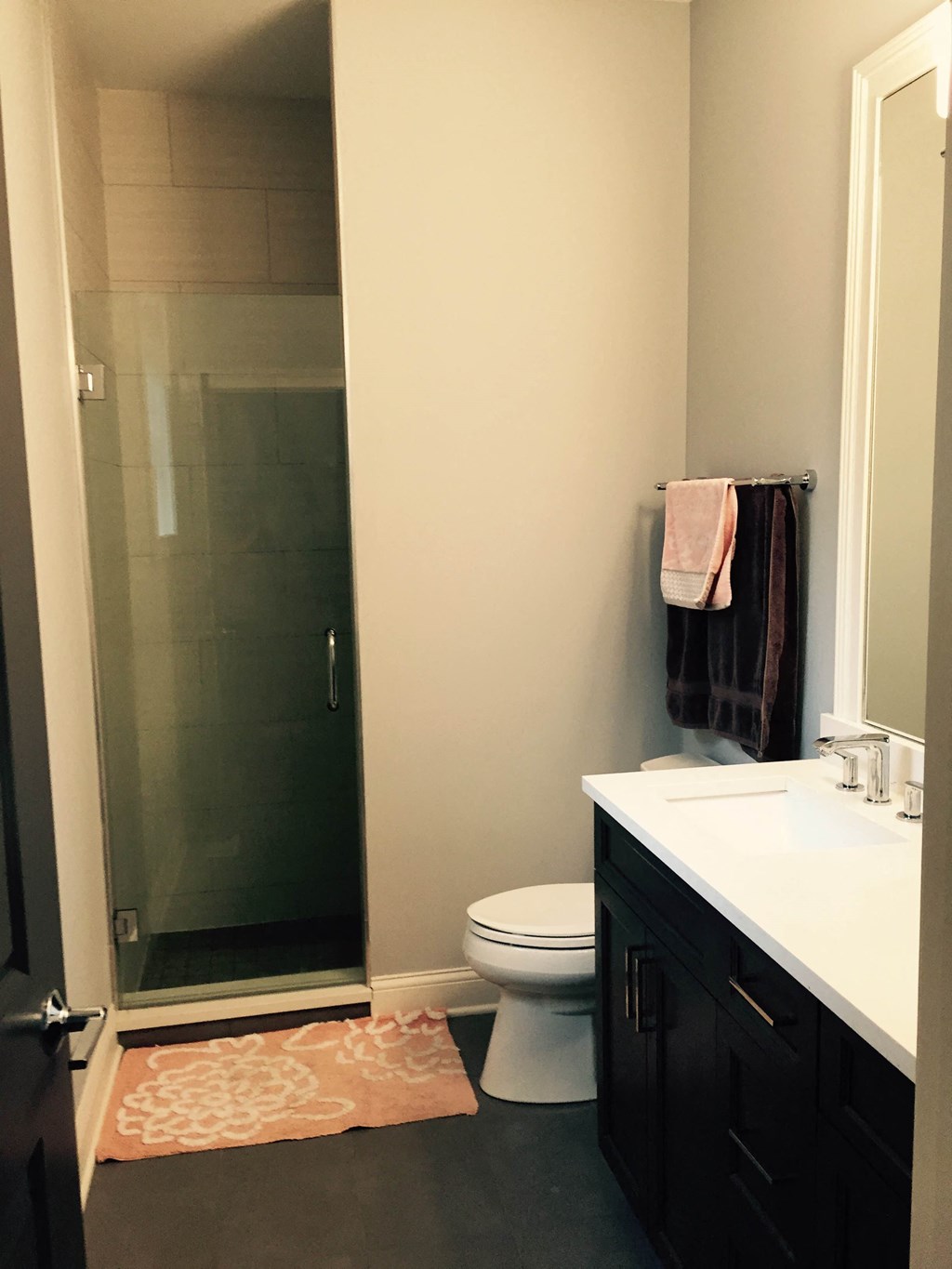 a small bathroom with a shower toilet and sink