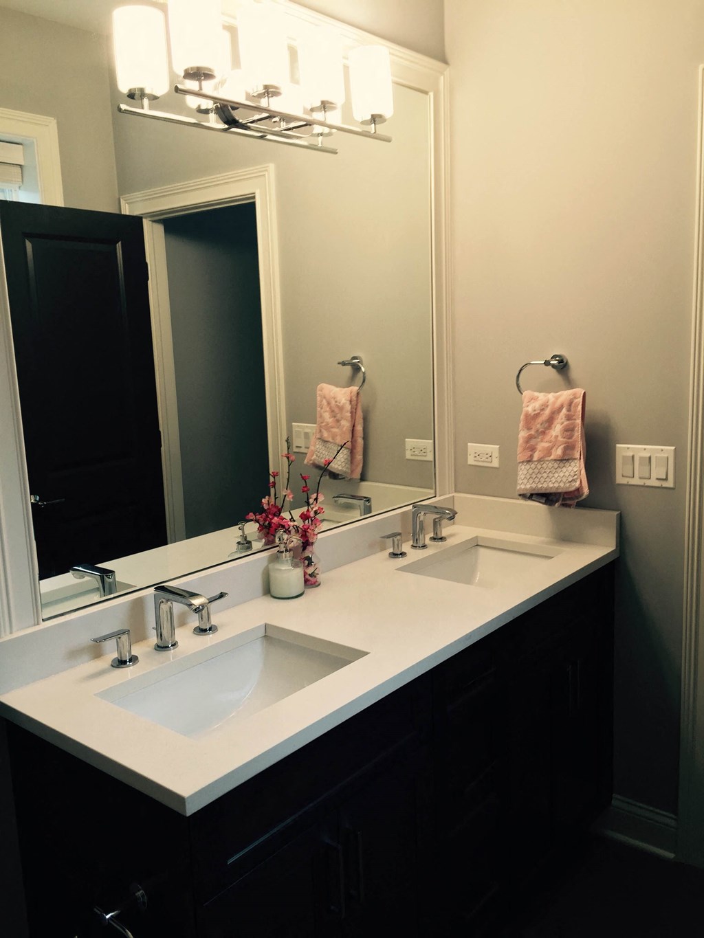 a bathroom with two sinks and a large mirror
