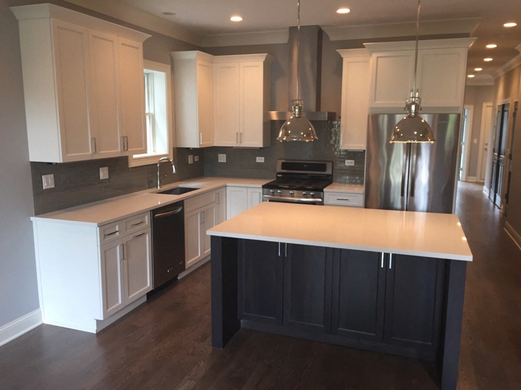a recent kitchen remodel with white cabinets and stainless steel appliances