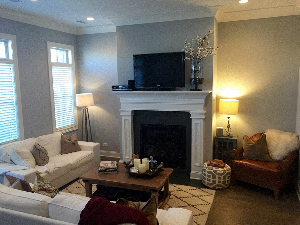 a living room with a fireplace and couches