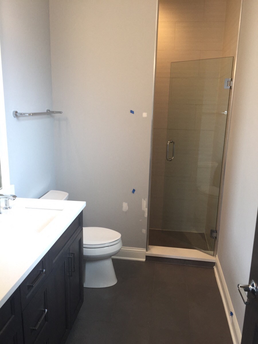 a bathroom with a shower and a sink and a toilet