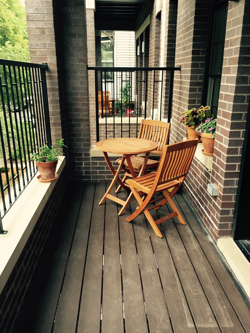 a patio with a table and chairs on a balcony